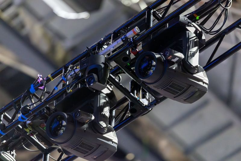 A closer view of the upside-down Canon CR-N700 PTZ camera, suspended between lights in the roof of the London arena.