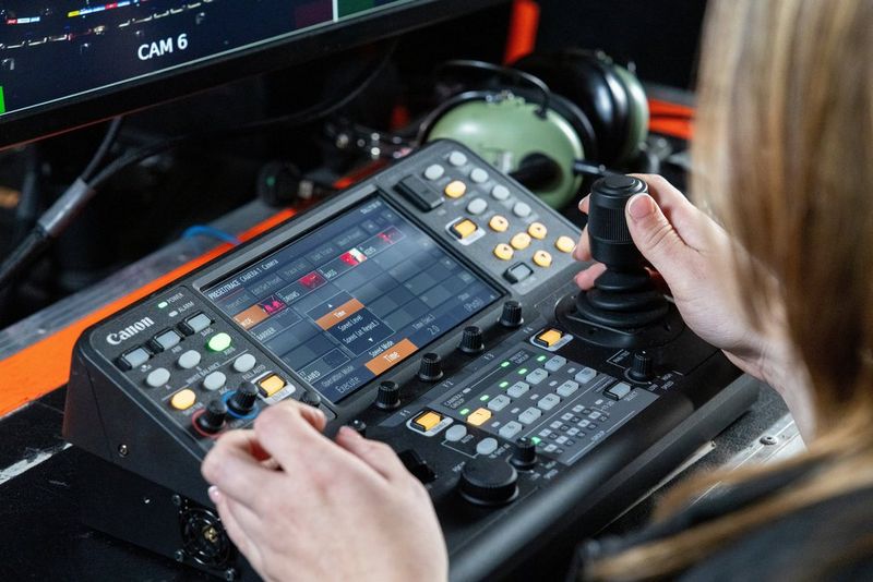 PTZ camera operator Harriet Woollam operates the Canon RC-IP1000 PTZ controller, with presets visible on the touchscreen.