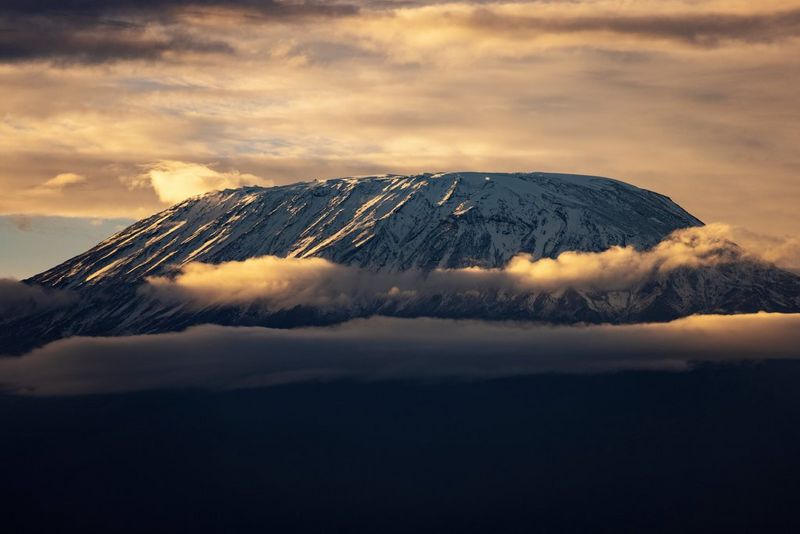 A huge, flat-topped mountain rises out of the mist.