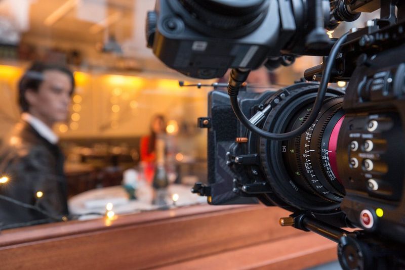 Filming the warmly lit interior of a restaurant through the window with a Canon EOS C700 FF camera and Sumire Prime cine lens.