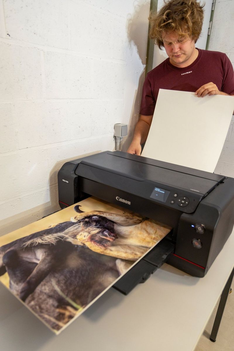 Timo Beke refills his Canon imagePROGRAF PRO-1100 printer with new paper.