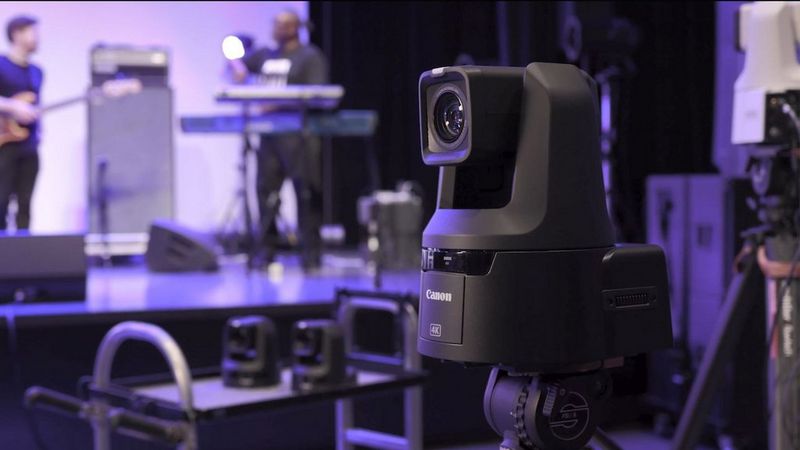 Pan Tilt Zoom camera filming a band performing