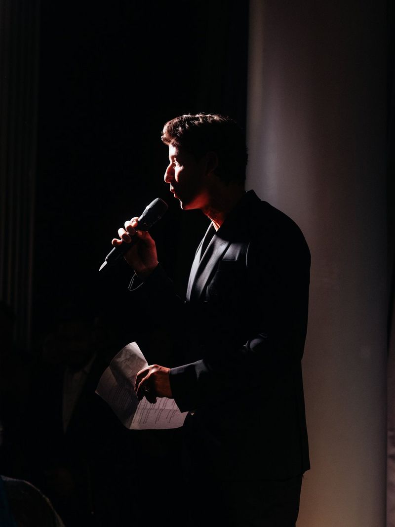 A silhouetted image of a man talking on a microphone at the Raindance Icon Awards 2026.