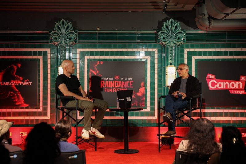 Award-winning cinematographer Haris Zambarloukos speaking on a cinematography panel at Raindance Film Festival 2026 with Ben Morse from Canon Europe.