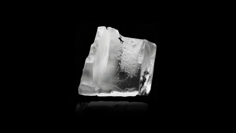 In a composite image by Delphin Montessuit, a cave climber is seen in silhouette apparently within a jagged block of ice.