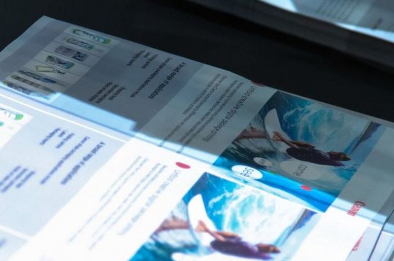 Promotional direct mail sitting on a printer