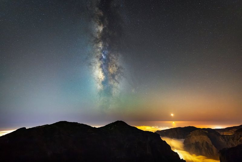 The Milky Way and Moon setting above Madeira, captured on the ultra-wide Canon RF 14mm F1.4L VCM lens.