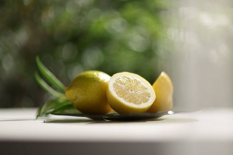 A still life photo of lemons taken at an aperture of f/1.2, with soft bokeh visible in the background and foreground.