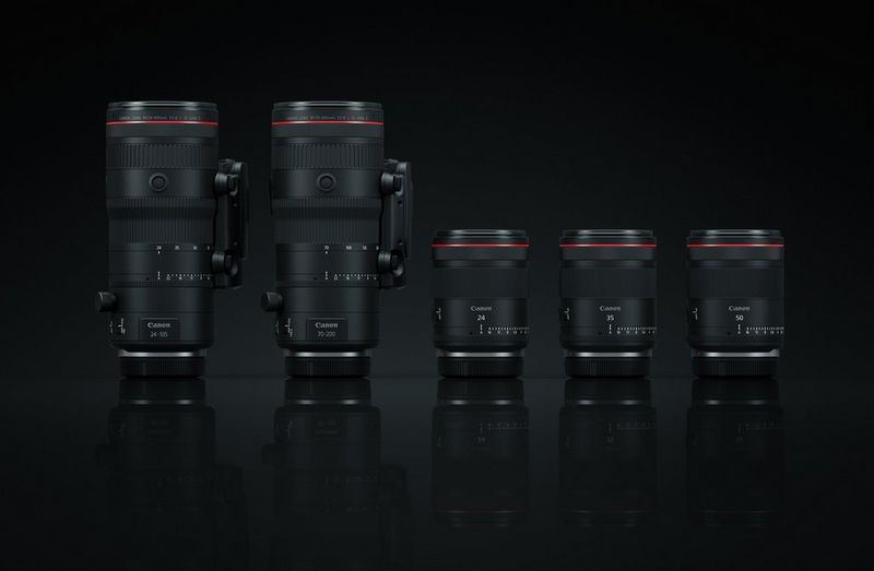 Canon's serie hybride RF-lenzen, twee zoomlenzen en drie primes, afgebeeld tegen een zwarte achtergrond.