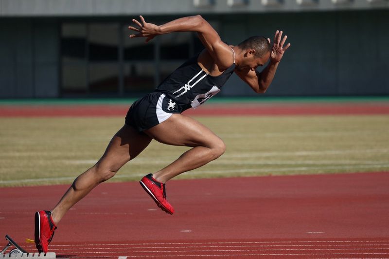 A runner photographed with a 600mm telephoto lens just as he leaves the starting block.