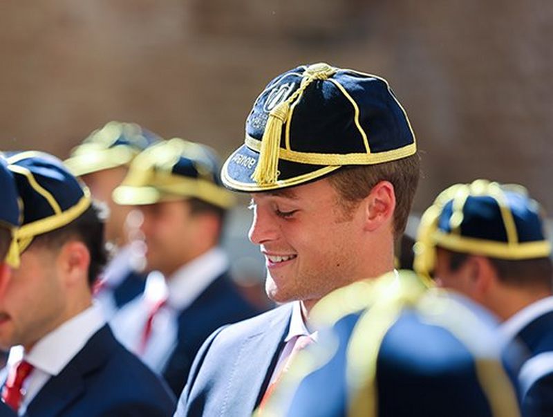 Jerónimo Portela smiles while wearing the Portugal rugby cap and a blazer
