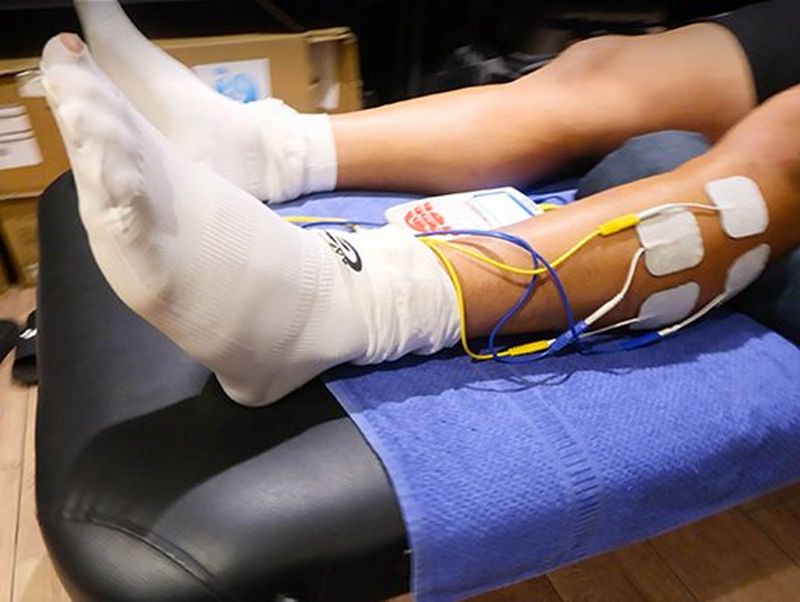 A pair of legs on the treatment table during physio 