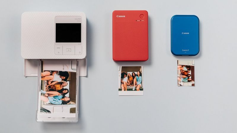 A collection of compact Canon photo printers in various colours. 