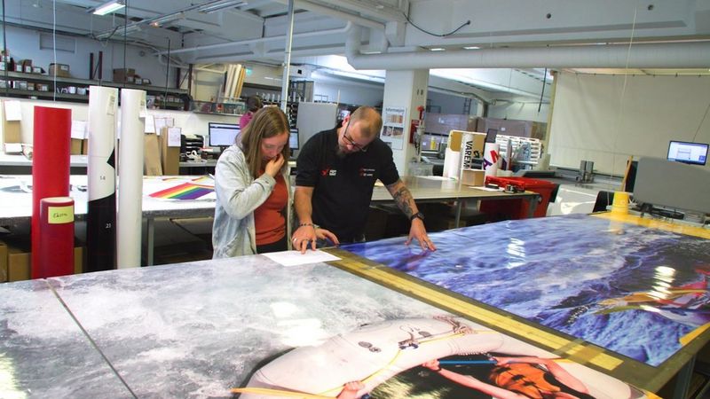 Employees of Sign Production checking retail prints
