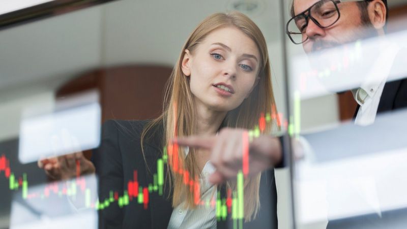 Colleagues talking profit on a graph