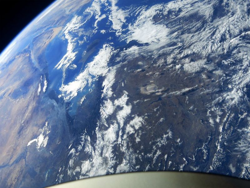 A satellite view of Turkey, focusing on a large landmass with mountains, clouds, and a coastline.