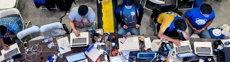 bird's-eye view of a group of people working on their laptops. 
