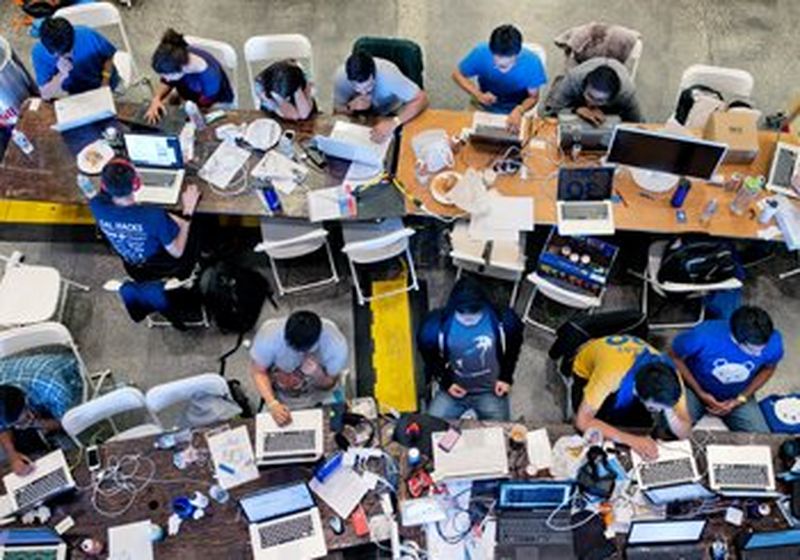 a bird&#39;s-eye view of group of people working on their laptops 