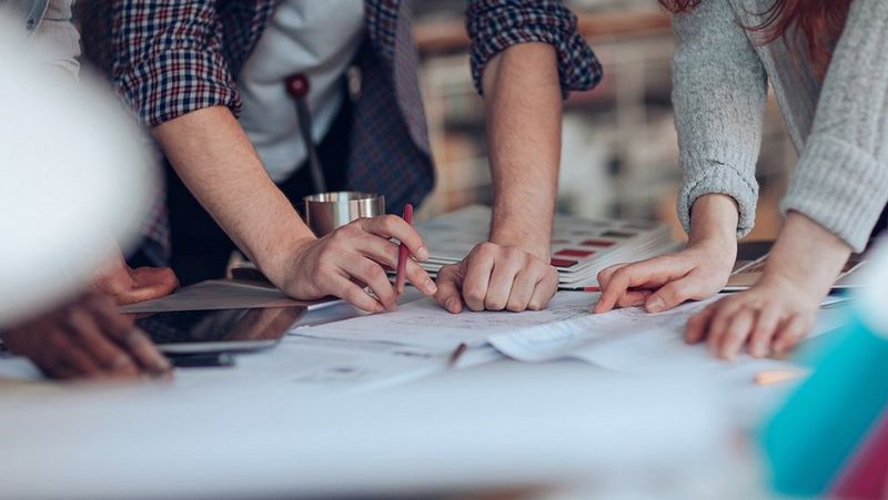 work-team-at-table-with-documents