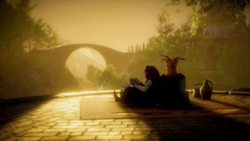 The figure of a person seated on the paved ground with their back against a tree stump. They are reading a book, but the light and shade obscures the detail of how they look or what they are wearing. In the background of the image are trees and a bridge, seen from the side. The sun shines golden through the bridge, illuminating the ground in front of the figure and some of the trees.