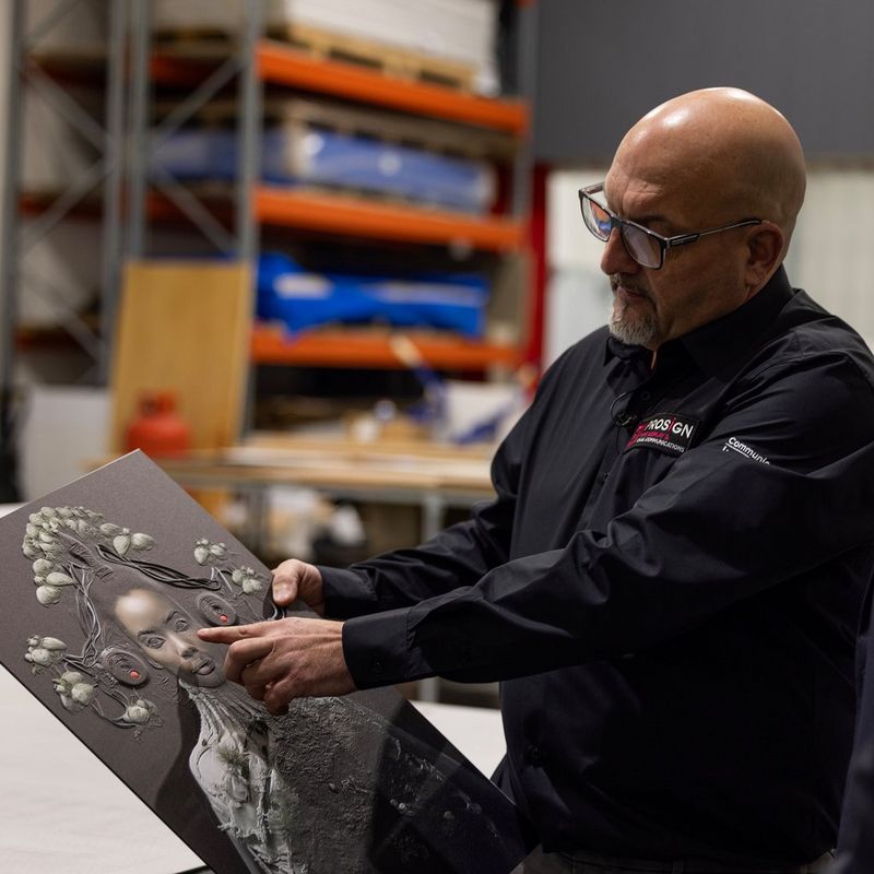 A fourth image in this block shows the print service provider from Prosign holding another example of an elevated print. He is pointing at the raised texture.