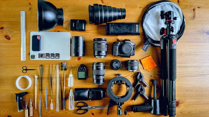 An overhead shot of Yasmin Albatoul's kitbag containing Canon cameras, lenses, and cooking props. Shot on Canon.