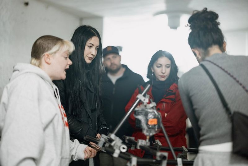 Filmmaker Jade Ang Jackman looks at the viewscreen of a Canon cinema camera. Around her are several other female crew members.