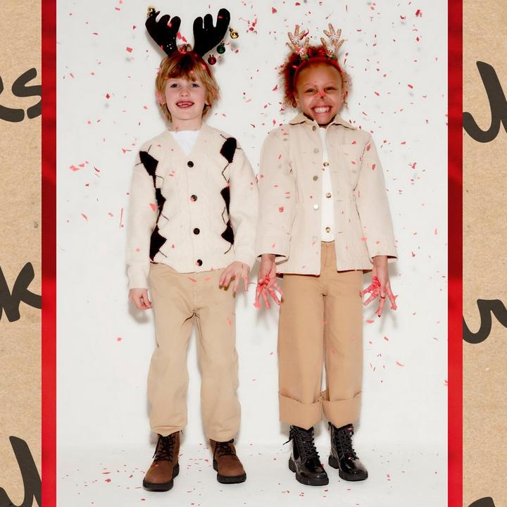 Boy and girl wearing festive clothes and Clarks Evyn Top and Evyn Charm boots.