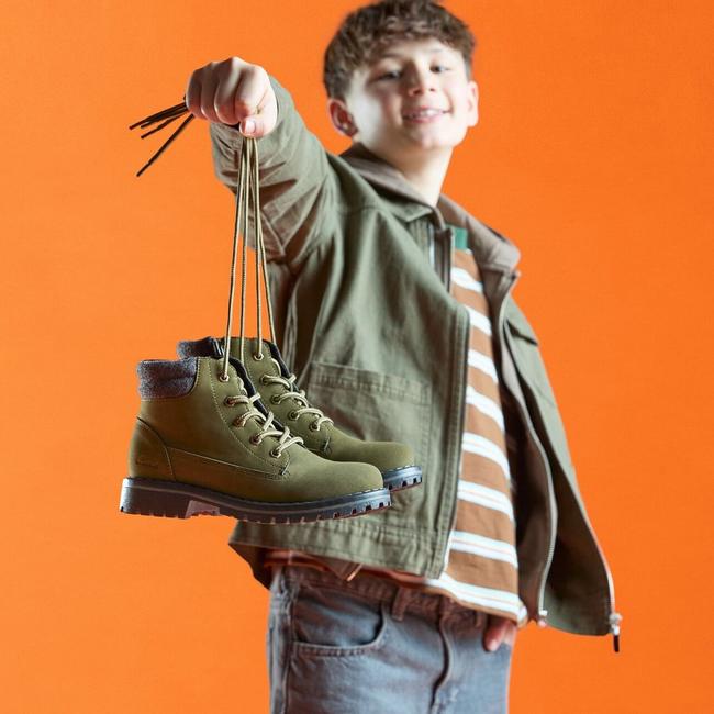 boy holding a pair of cliff lace boots