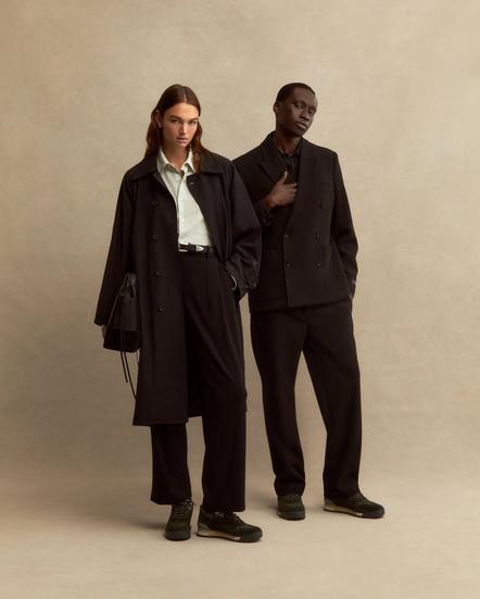 A woman and man stood dressed in black wearing 8th St by Ronnie Fieg | Shop now