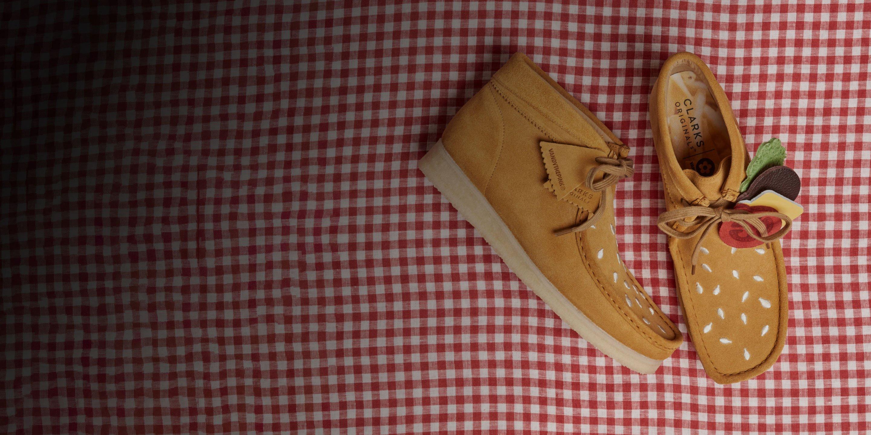 Aerial view of Vandy the Pink x Clarks Originals collaboration wallabee boot on a table cloth | Shop this style