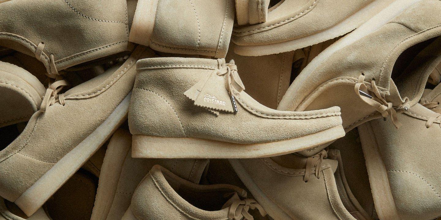 A pile of wallabee shoes and boots | Shop Wallabees
