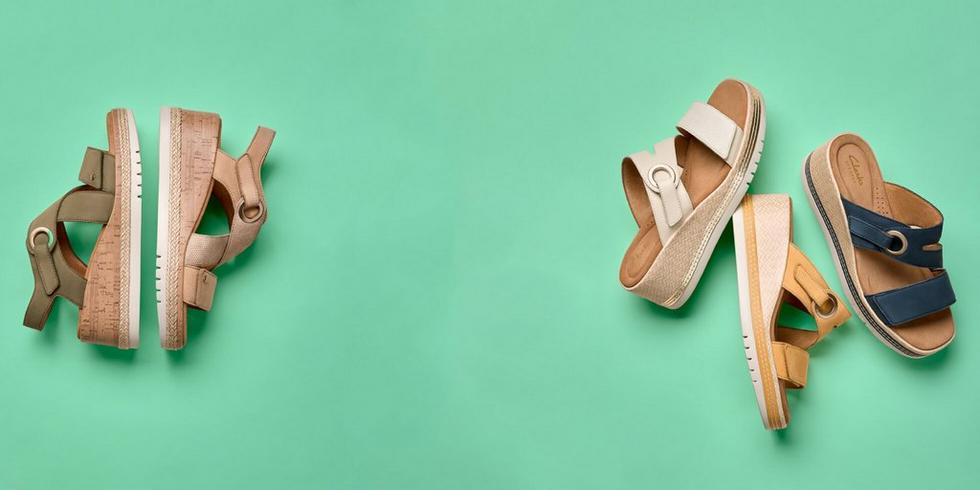 A selection of sandals from the Kidiki collection on a green background