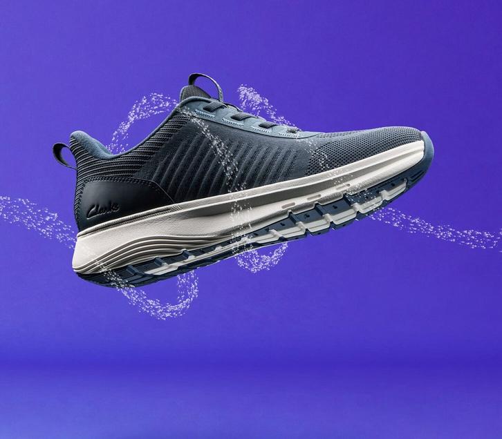 Side view of a Clarks Motion Tread shoe floating on a purple background