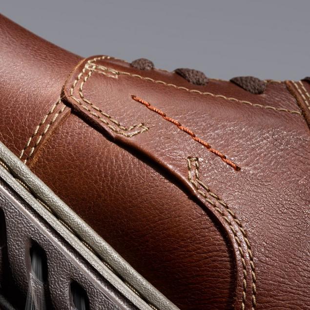 Close-up of brown shoe Un Briley Pace’s side, showing stitching details on leather