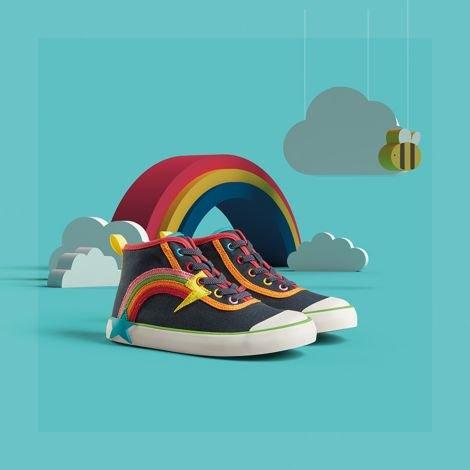 Pair of Foxing Hi Beau Kid Navy Combination shoes on a blue background with clouds and a rainbow.