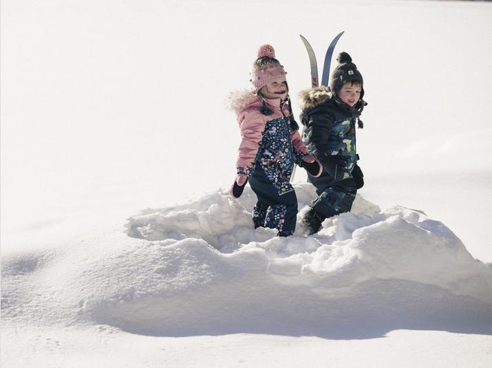 Children wearing Deux par Deux winter clothing while playing in the snow