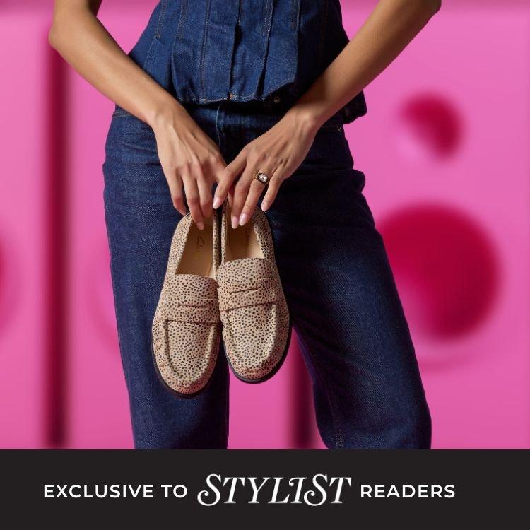 Clarks x Stylist women in denim holdinng Clarks speckled loafers