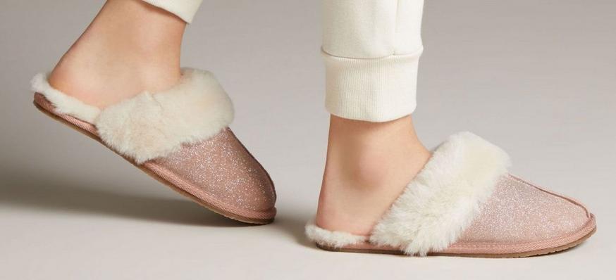 Close-up shot of women’s blush pink leather mule slippers with shearling lining, Warm Glitz