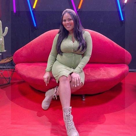 Kamilla sitting on a sofa at an event