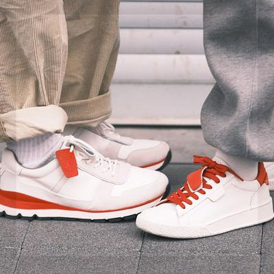 A photo of mens and womens trainers facing eachother