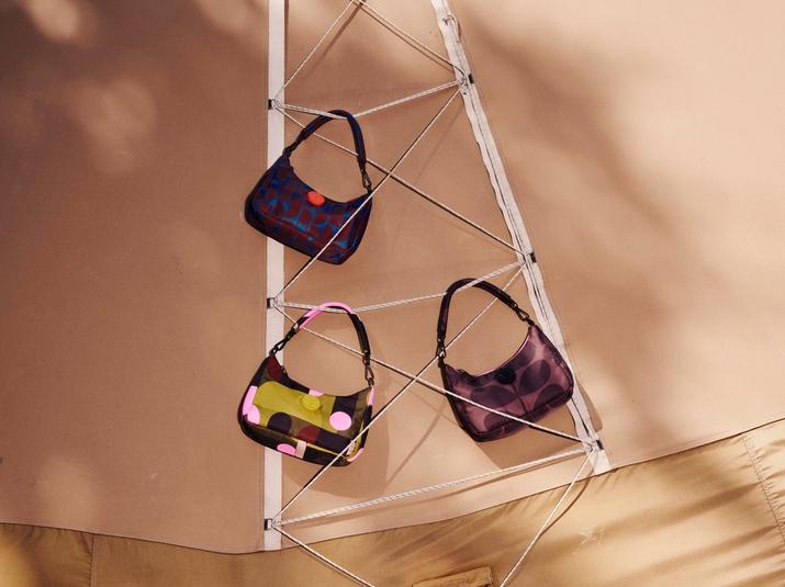 Three Orla Kiely patterned shoulder bags displayed against a canvas backdrop