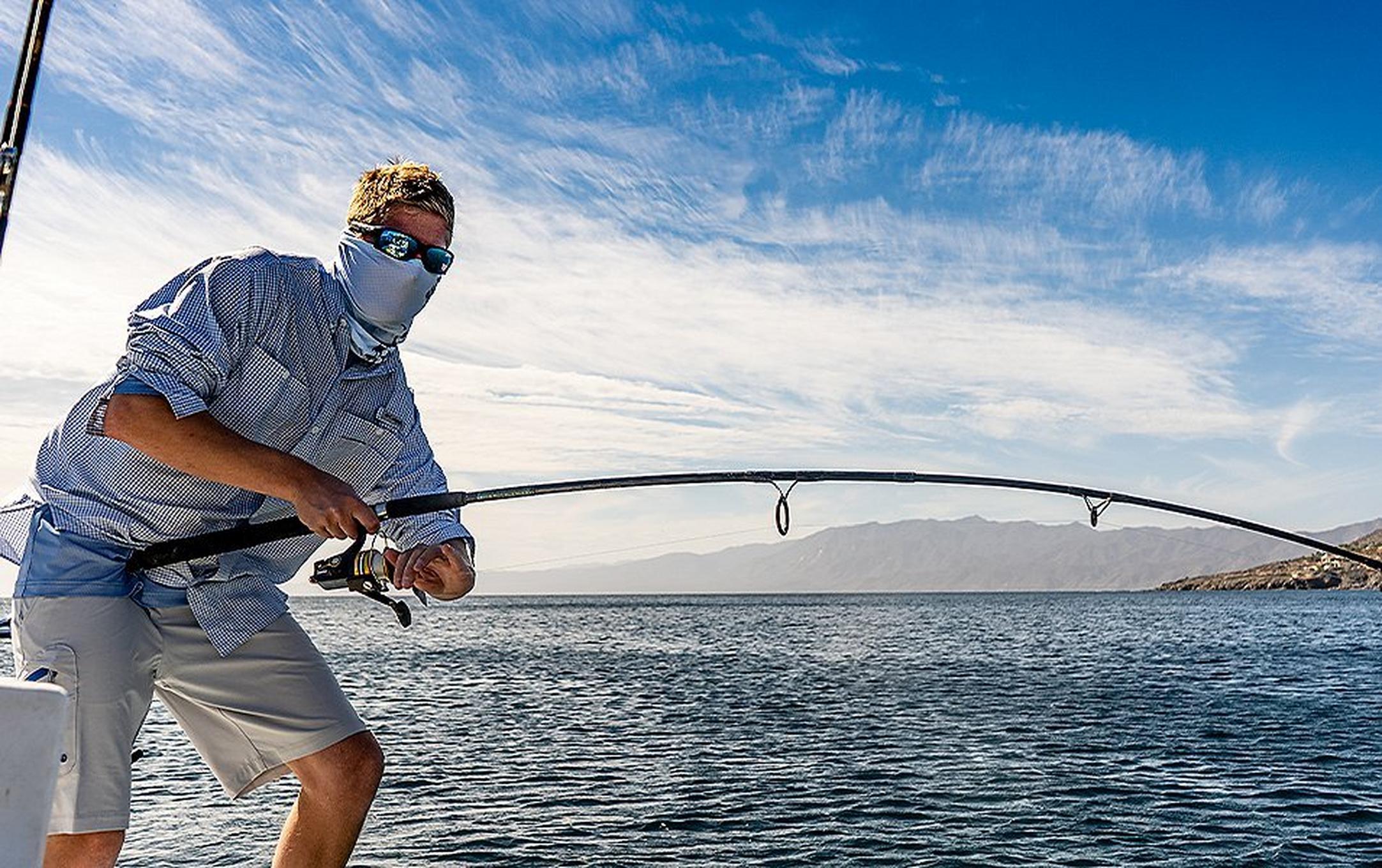 Marq Lazicky reeling a line on a sunny day.