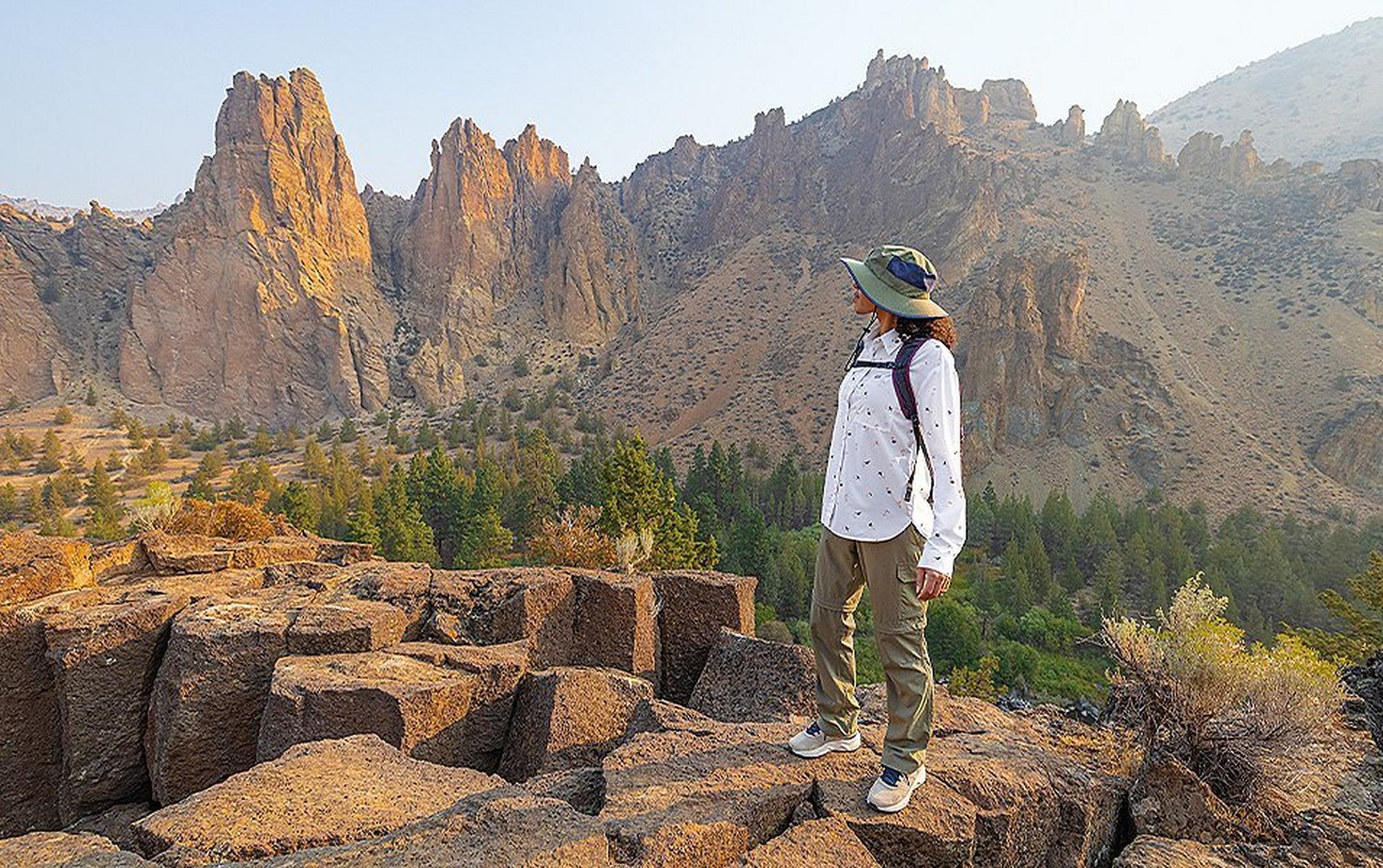A woman hikes alone in a beautiful high desert landscape.