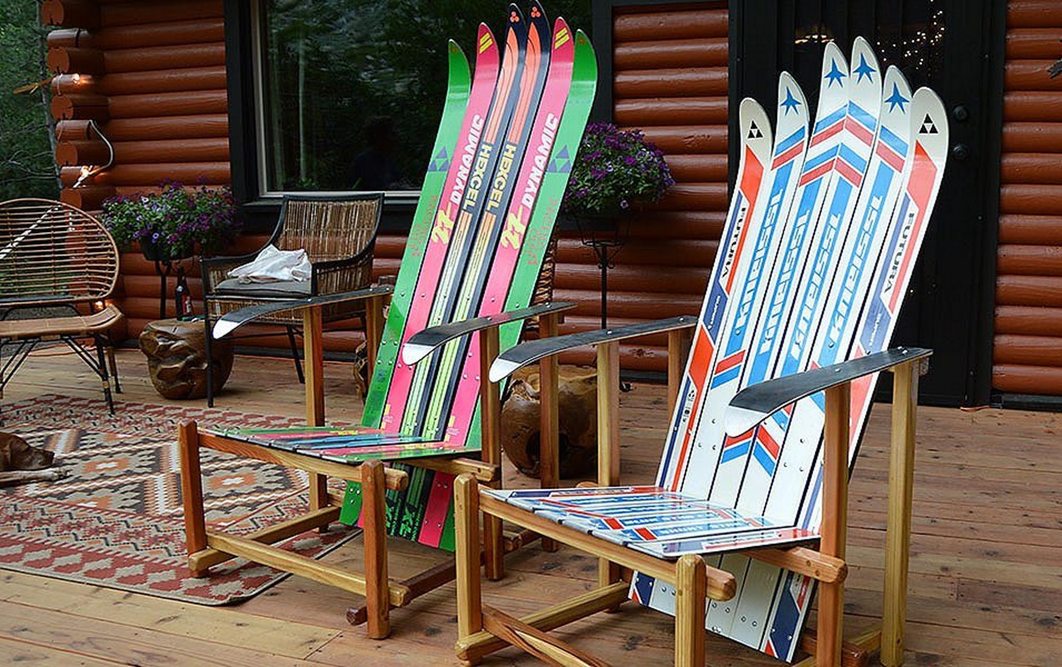 Two deck lounge chairs made by Forest Furniture sit on a deck outside.