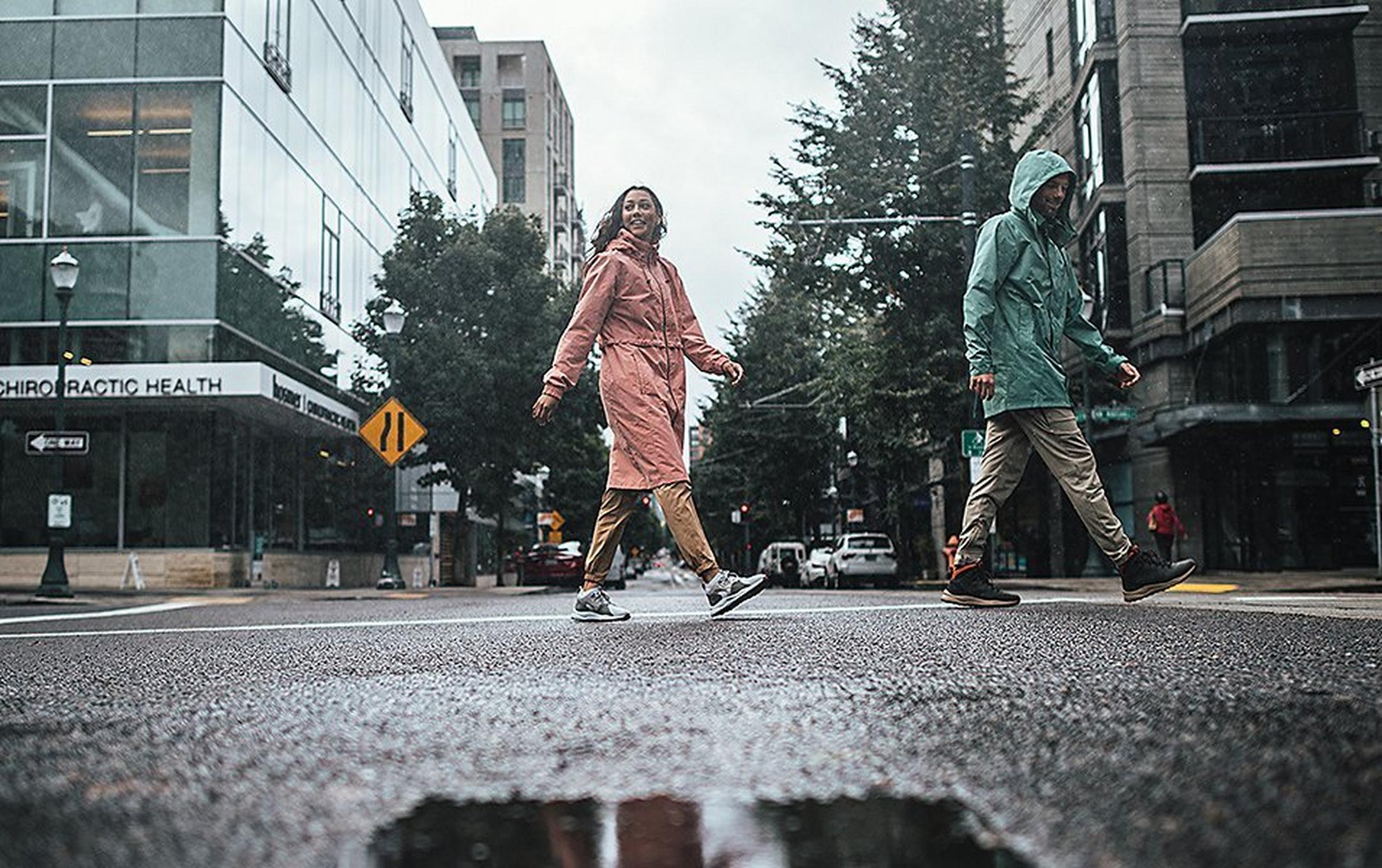 Two people walking in a city street on a rainy day.