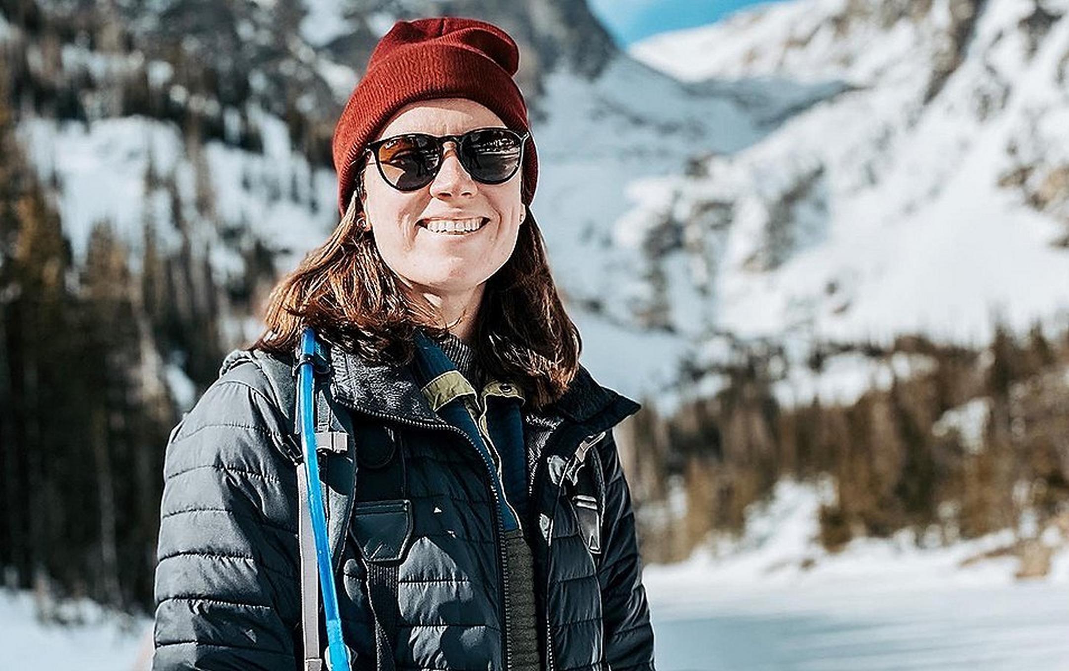 Savanna Shackleford smiles at the camera with scenic mountains blurred out in the background.