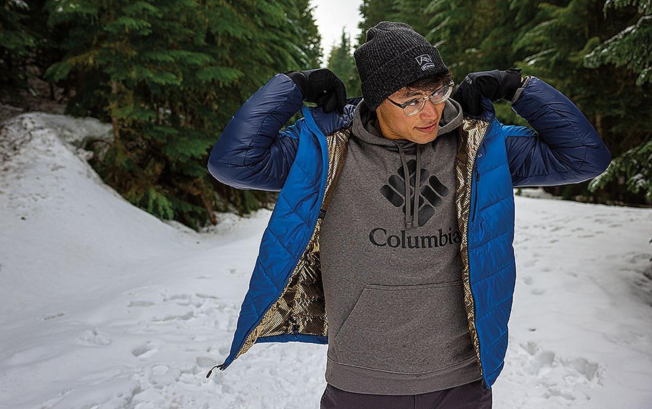 An outdoorsman adjusts the lining on his Omni-Heat Infinity winter jacket.