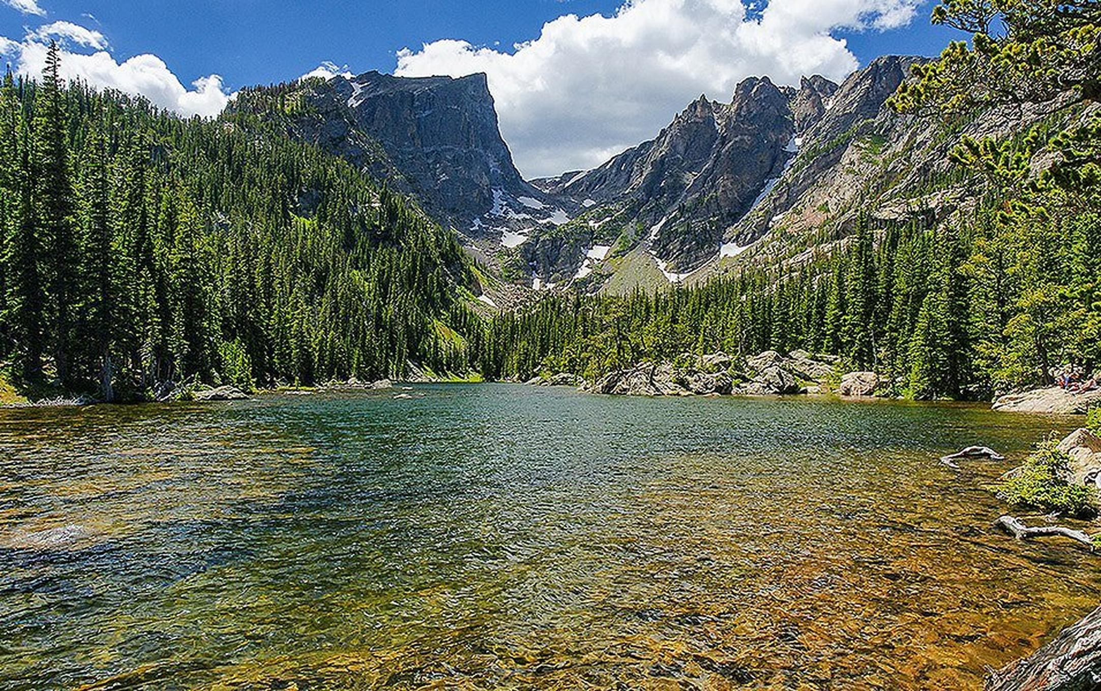 Sweeping granite peaks, a crystal-clear glacier-fed lake, and big pine forests of Rocky Mountain National Park.
