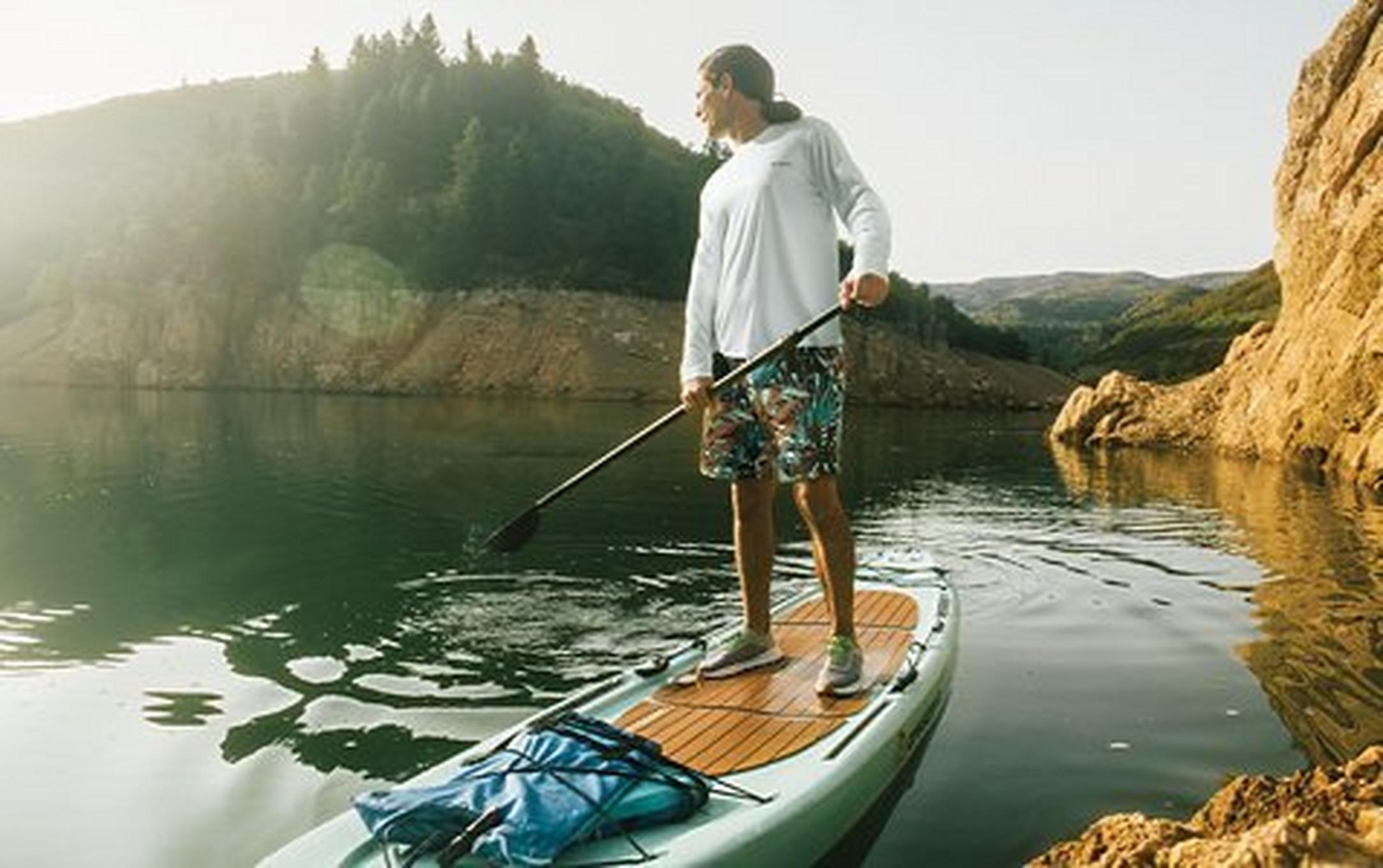 Person on a paddle board on a summer day.